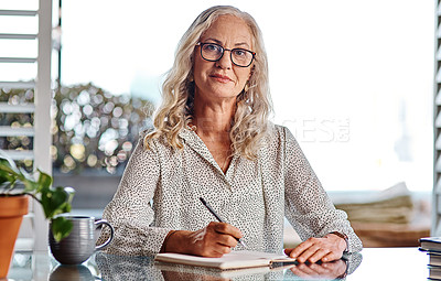 Buy stock photo Cropped portrait of an attractive senior businesswoman working from home