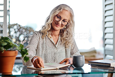 Buy stock photo Happy, mature woman and home as author with journal in desk for novel publishing as freelancer. Female person, publisher and smile with remote work for books, literature and fiction storyline