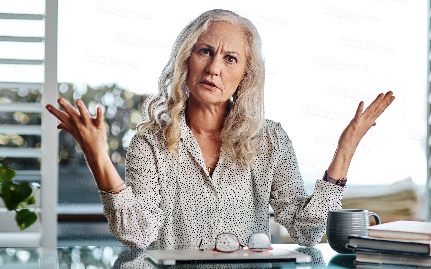 Buy stock photo Cropped portrait of an attractive senior businesswoman looking confused while working from home