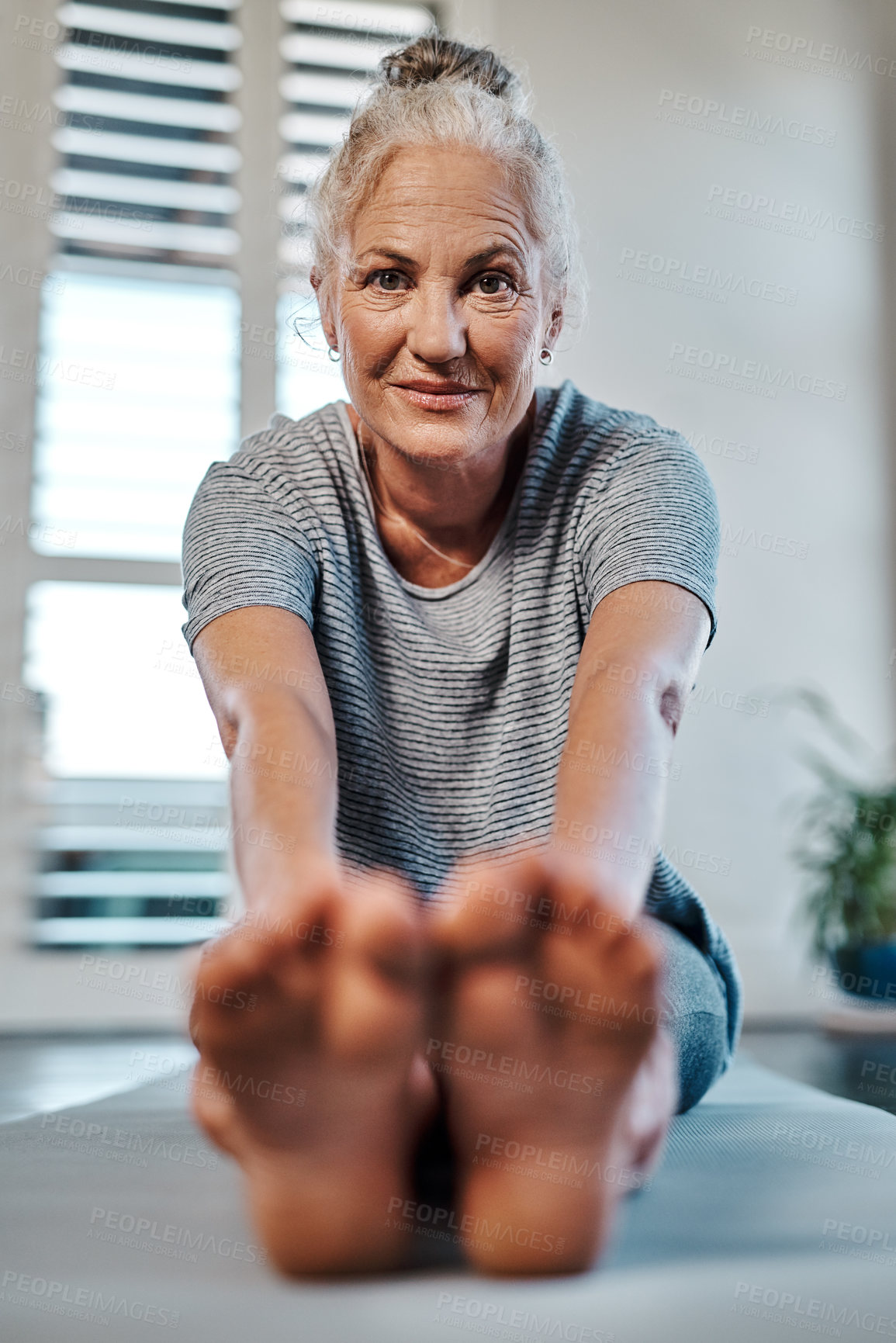Buy stock photo Portrait of a cheerful mature woman practicing yoga inside of a studio during the day