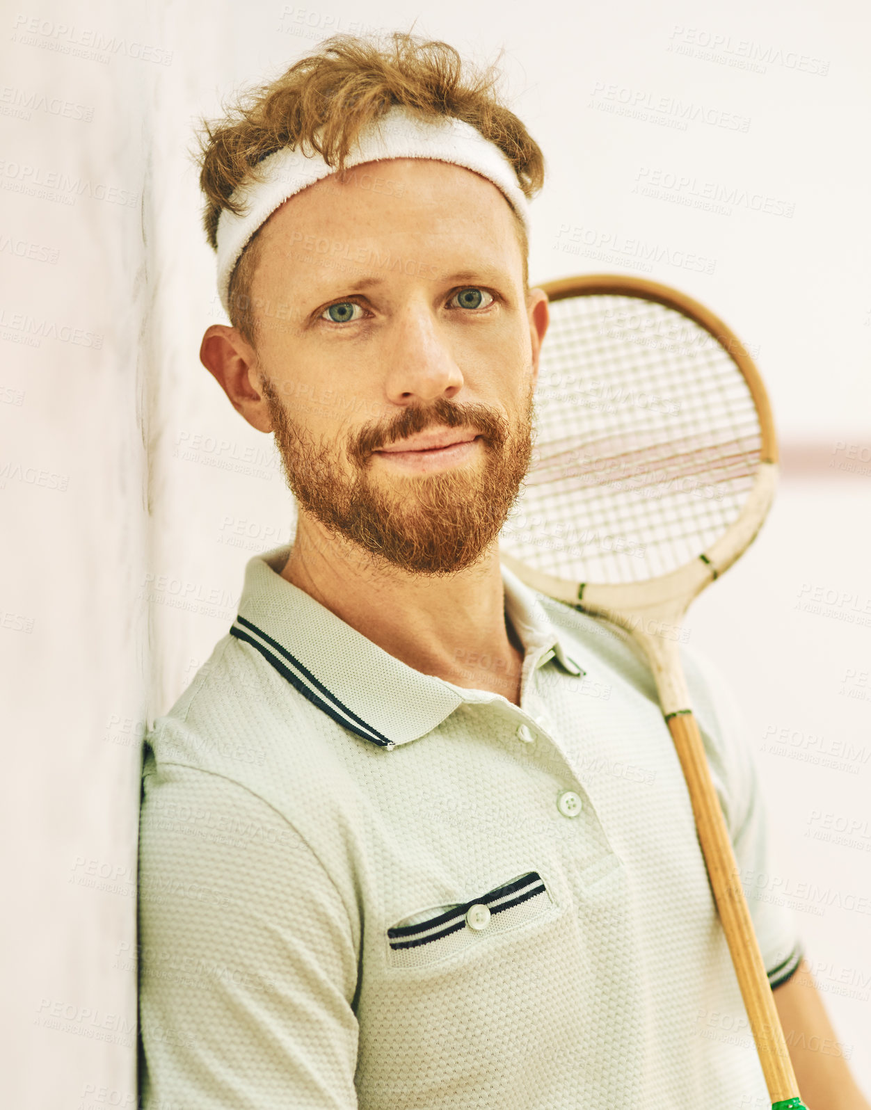 Buy stock photo Shot of a confident young man standing on a squash court