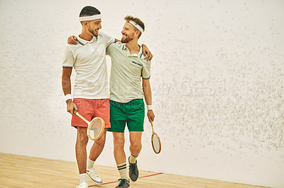 Buy stock photo Shot of two young men embracing at a squash court