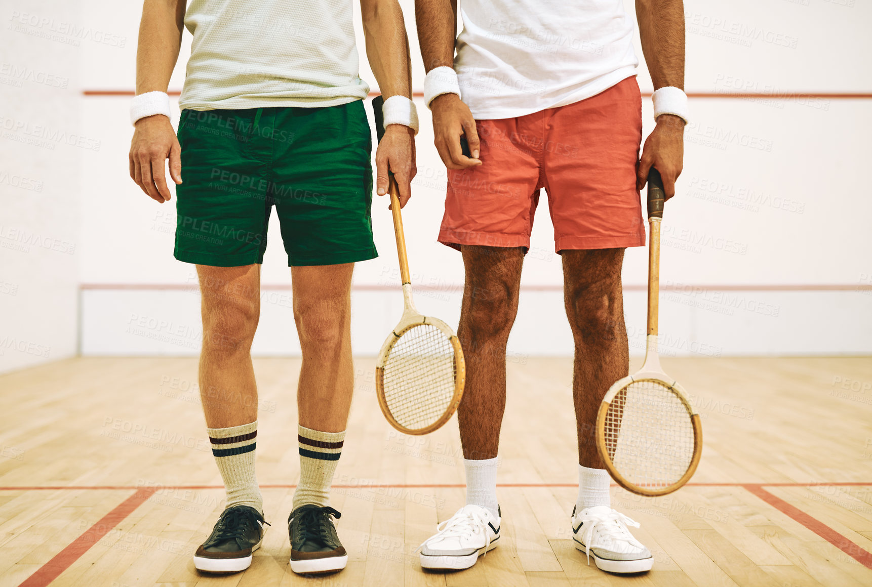 Buy stock photo Cropped shot of two men holding their racquets at a squash court