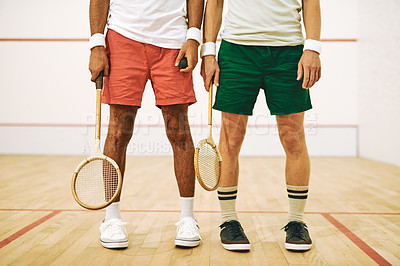 Buy stock photo Cropped shot of two men holding their racquets at a squash court