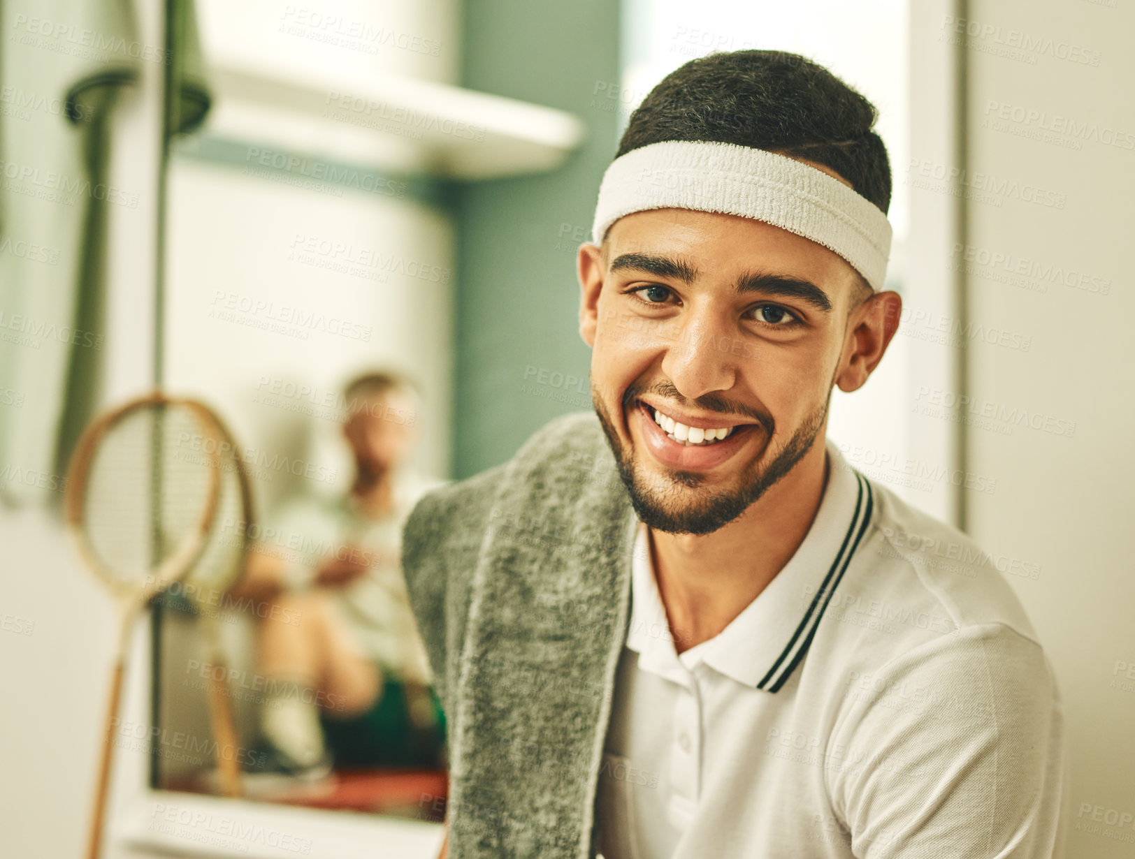 Buy stock photo Shot of a young man taking a break in the locker room after a game of squash