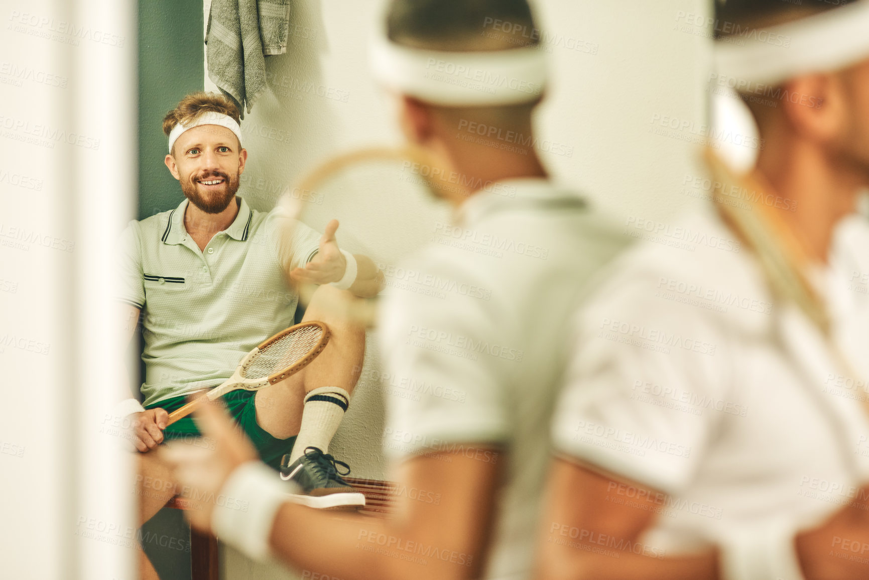 Buy stock photo Shot of two young men chatting in the locker room after a game of squash