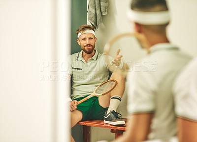 Buy stock photo Shot of two young men chatting in the locker room after a game of squash