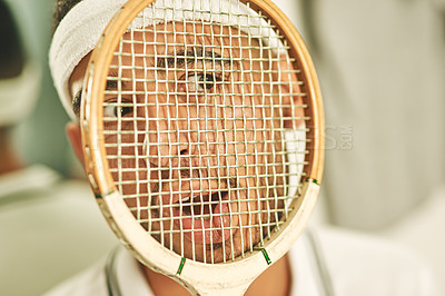 Buy stock photo Shot of a young man pressing his face up against his squash racket