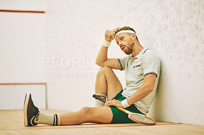 Buy stock photo Squash, tired and rest of man for sport, training and practice for competition challenge in court. Indoor club, male player and breathing on break for game match, tournament and racket for fitness