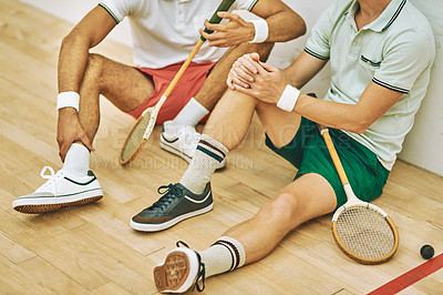Buy stock photo Cropped shot of two men taking a break after playing a game of squash