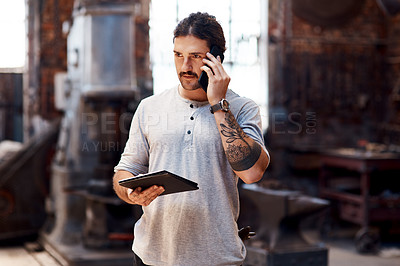 Buy stock photo Phone call, tablet and thinking with man in workshop for communication, manufacturing or production. Craftsmanship, forge and online order with blacksmith talking on mobile for industrial metalwork