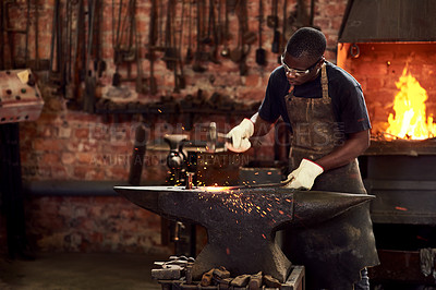 Buy stock photo Blacksmith, worker and metal forge in workshop and manual industry working on hot steel with hammer, sparks or fire. Black man, welding or iron tools manufacturing or expert, trade and dark workspace