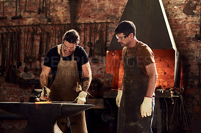 Buy stock photo Men, blacksmith and metal teamwork in workshop for manufacturing steel, welding or fire. Male people, production and collaboration for restoration project in warehouse as handyman, skills or repair