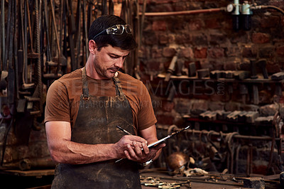 Buy stock photo Metal worker, clipboard and writing notes in workshop for manufacturing, welding and blacksmith. Tradesman, tools and equipment in factory with apron for artisan, industrial steel and manual labor