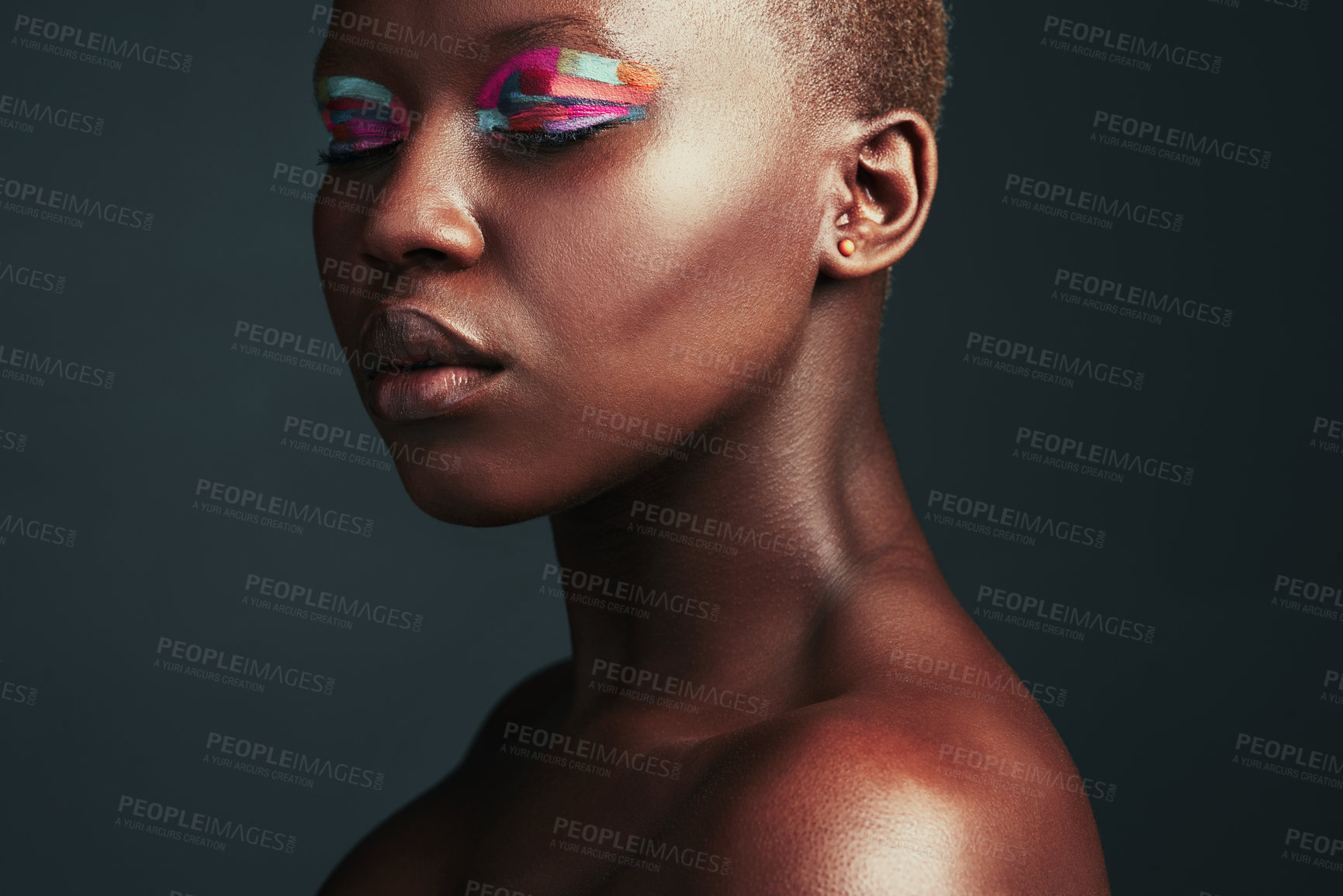 Buy stock photo Cropped shot of a beautiful woman wearing colorful eyeshadow while posing against a grey background