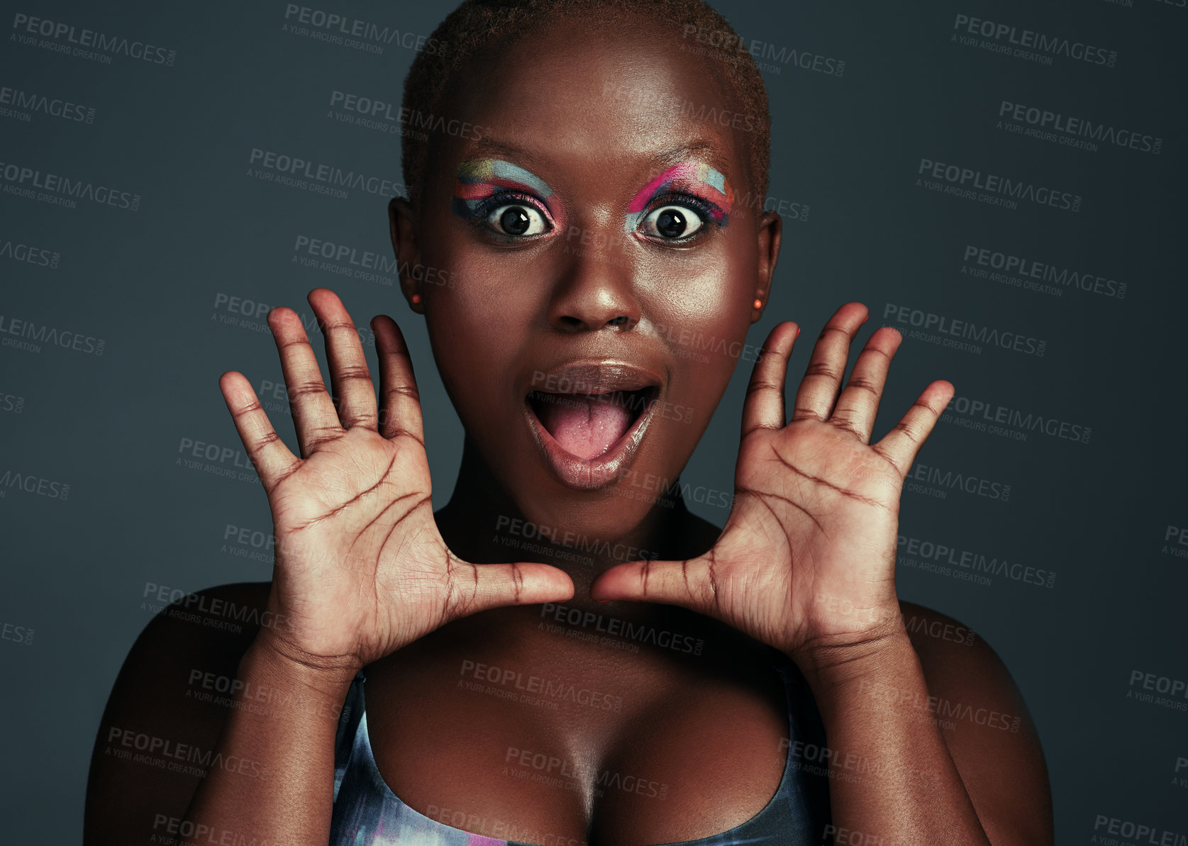 Buy stock photo Shot of a beautiful young woman looking surprised while posing against a grey background