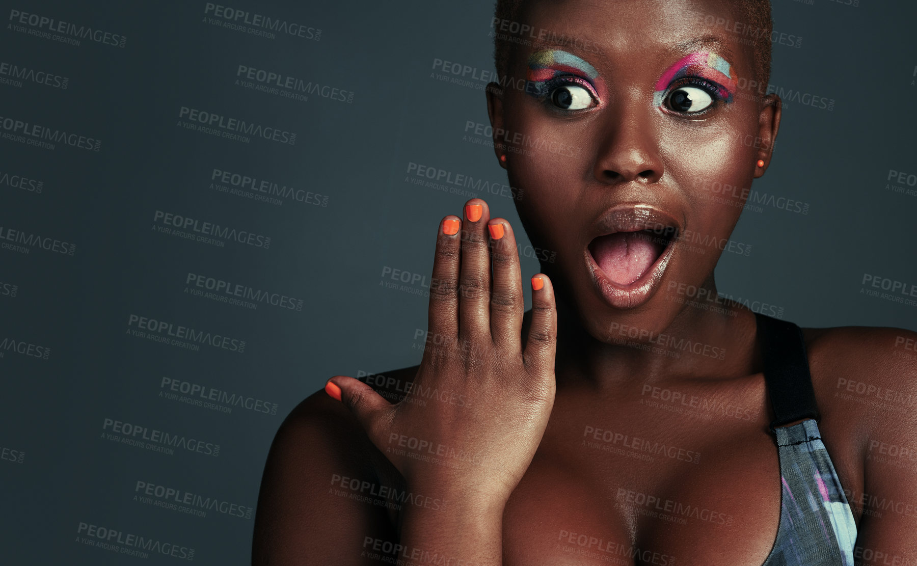 Buy stock photo Shot of a beautiful young woman looking surprised while posing against a grey background