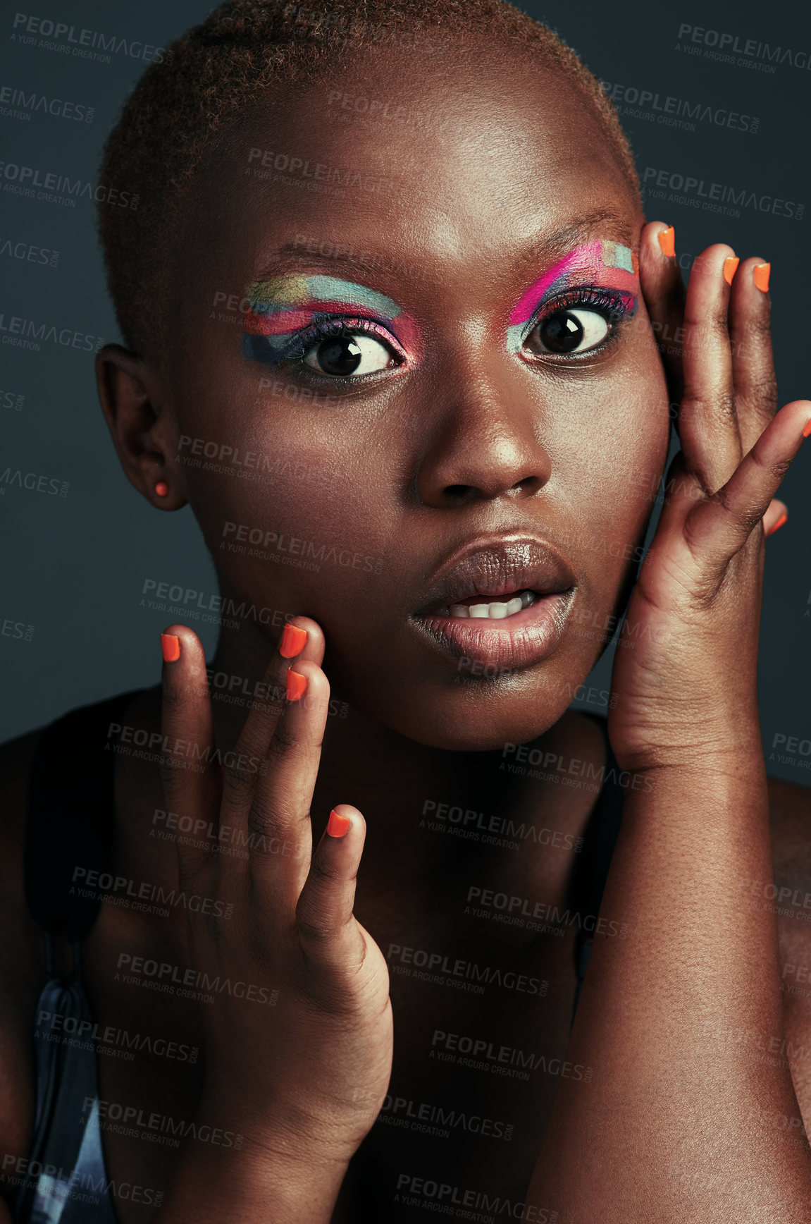 Buy stock photo Cropped shot of a beautiful woman wearing colorful eyeshadow while posing against a grey background