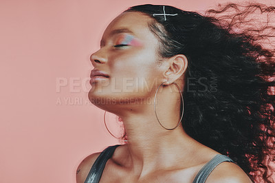 Buy stock photo Shot of a beautiful young woman wearing makeup while posing against a pink background