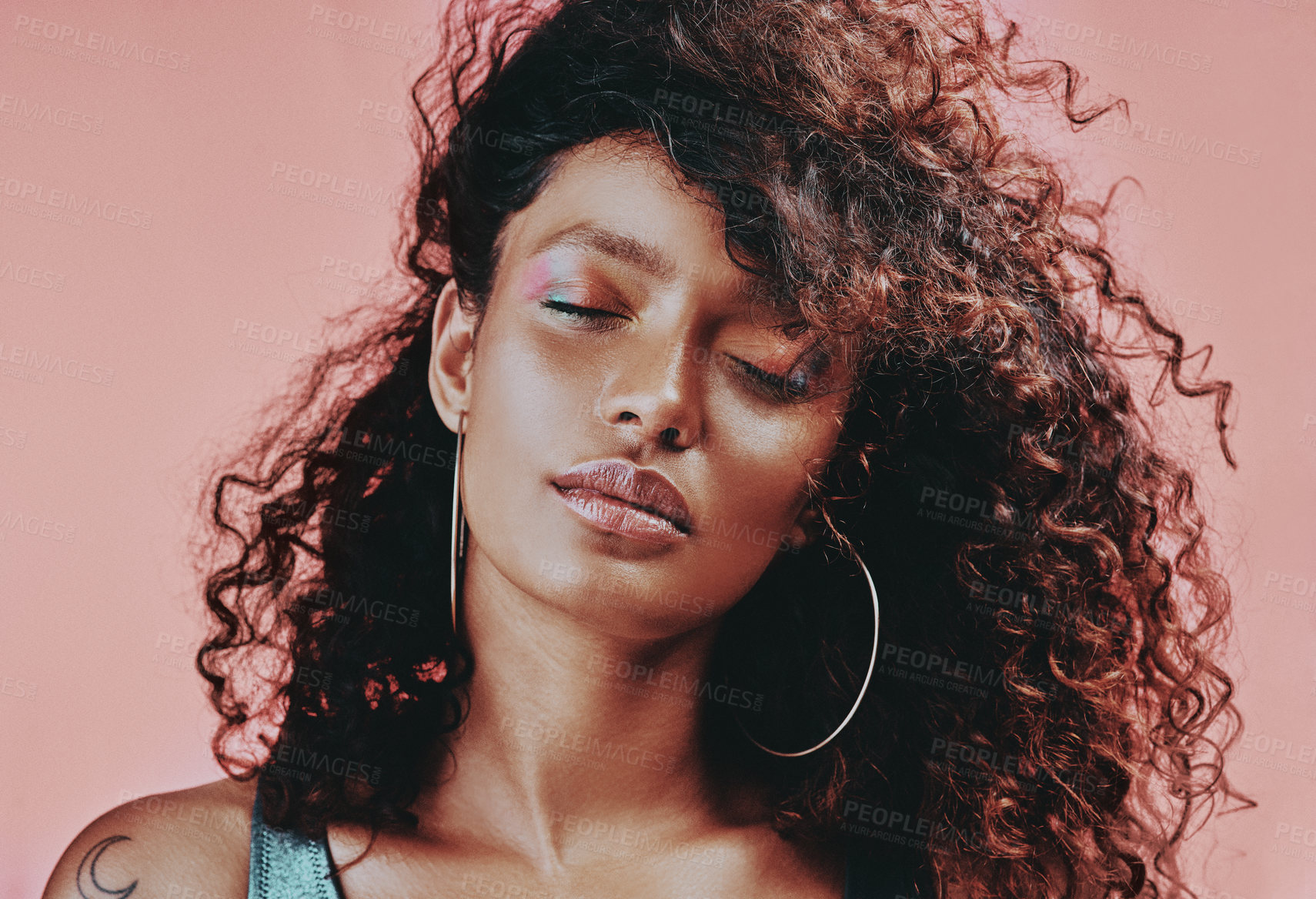 Buy stock photo Shot of a beautiful young woman wearing makeup while posing against a pink background