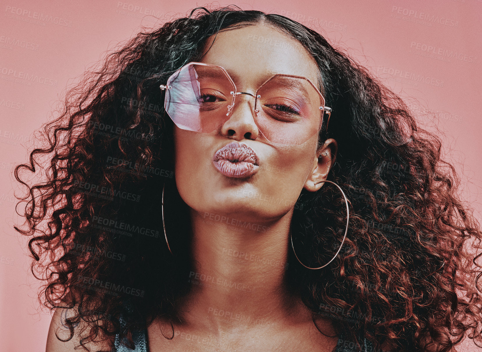 Buy stock photo Woman, sunglasses and pout in studio for beauty, cosmetic and glow on pink background. Curly hair, kiss and bold for model people, glam and glow for creative cosmetology and art aesthetic for makeup