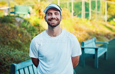 Buy stock photo Portrait of a sporty young man standing on a tennis court