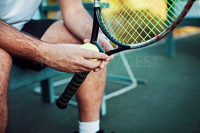 Buy stock photo Closeup shot of an unrecognisable man holding a tennis racket and ball on a tennis court