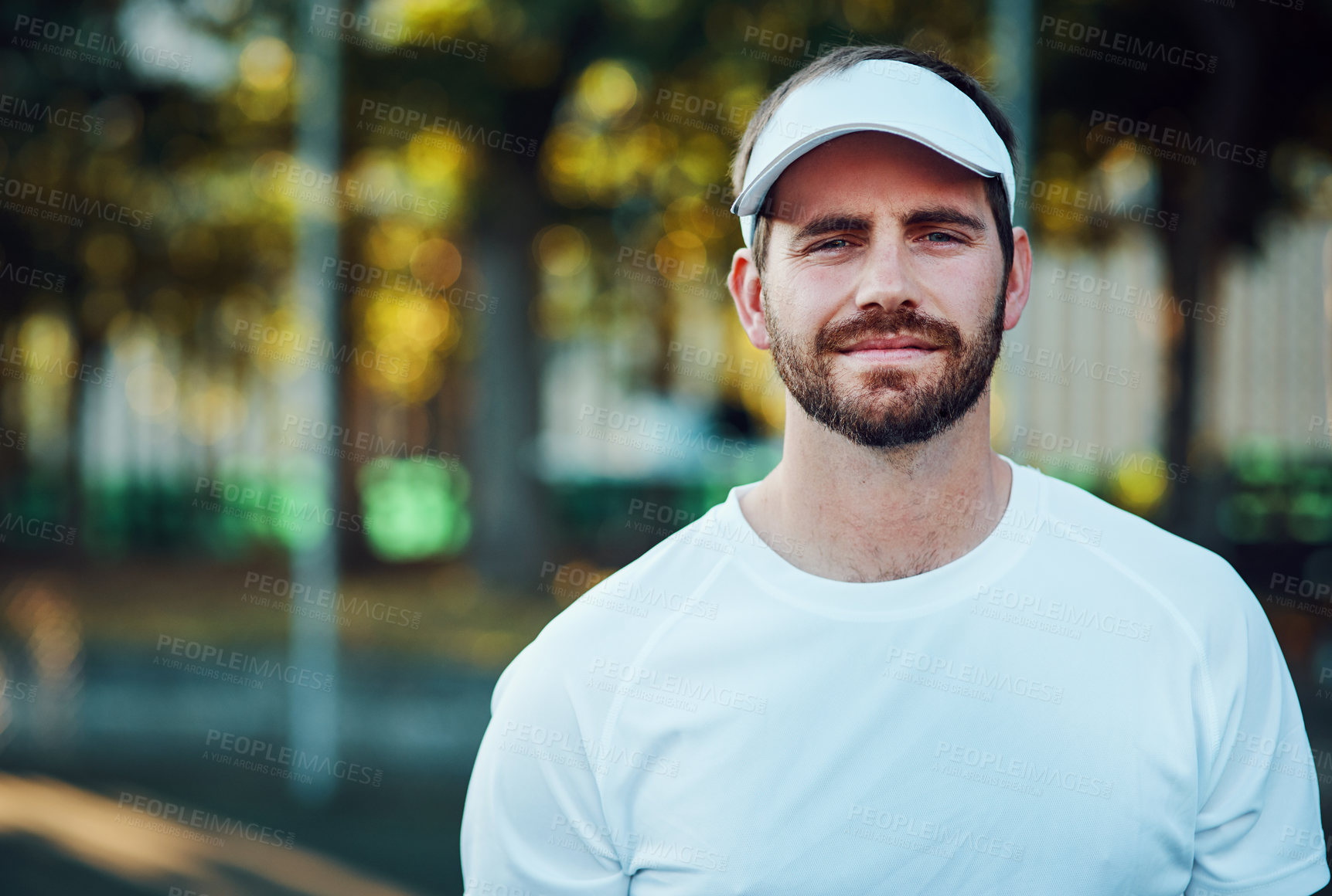 Buy stock photo Portrait of a sporty young man standing on a tennis court