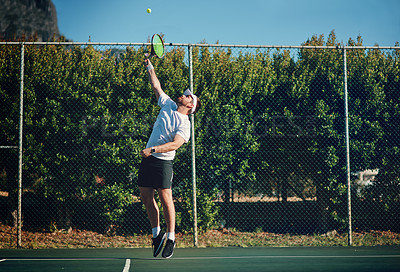 Buy stock photo Shot of a sporty young man playing tennis on a tennis court