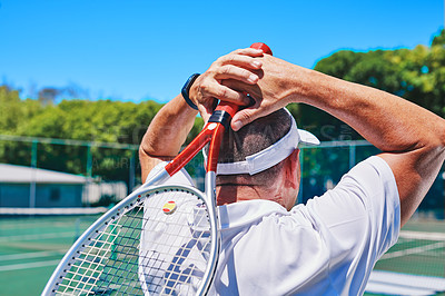 Buy stock photo Cropped shot of an unrecognizable sportsman standing alone on the court during the day