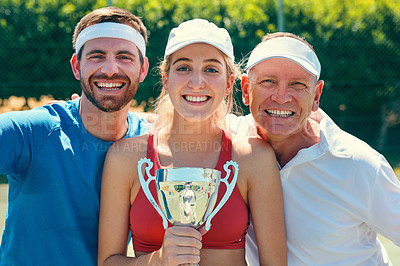 Buy stock photo Cropped portrait of a group of sportspeople standing together and holding a trophy after winning a tennis match