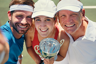 Buy stock photo Cropped portrait of a group of sportspeople standing together and holding a trophy after winning a tennis match