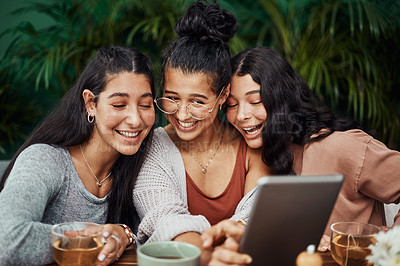 Buy stock photo Shot of young sisters taking selfies together at a cafe