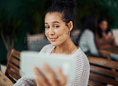 Buy stock photo Shot of a beautiful young woman taking selfies at a cafe
