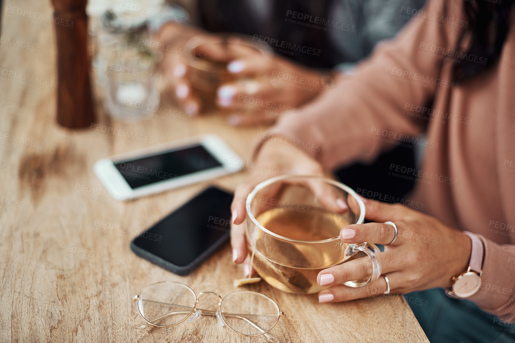 Buy stock photo Coffee shop, phone and hands of woman with drink, warm beverage and tea by window. Breakfast, friends and people with smartphone for social media, chatting and website in restaurant, diner or cafe