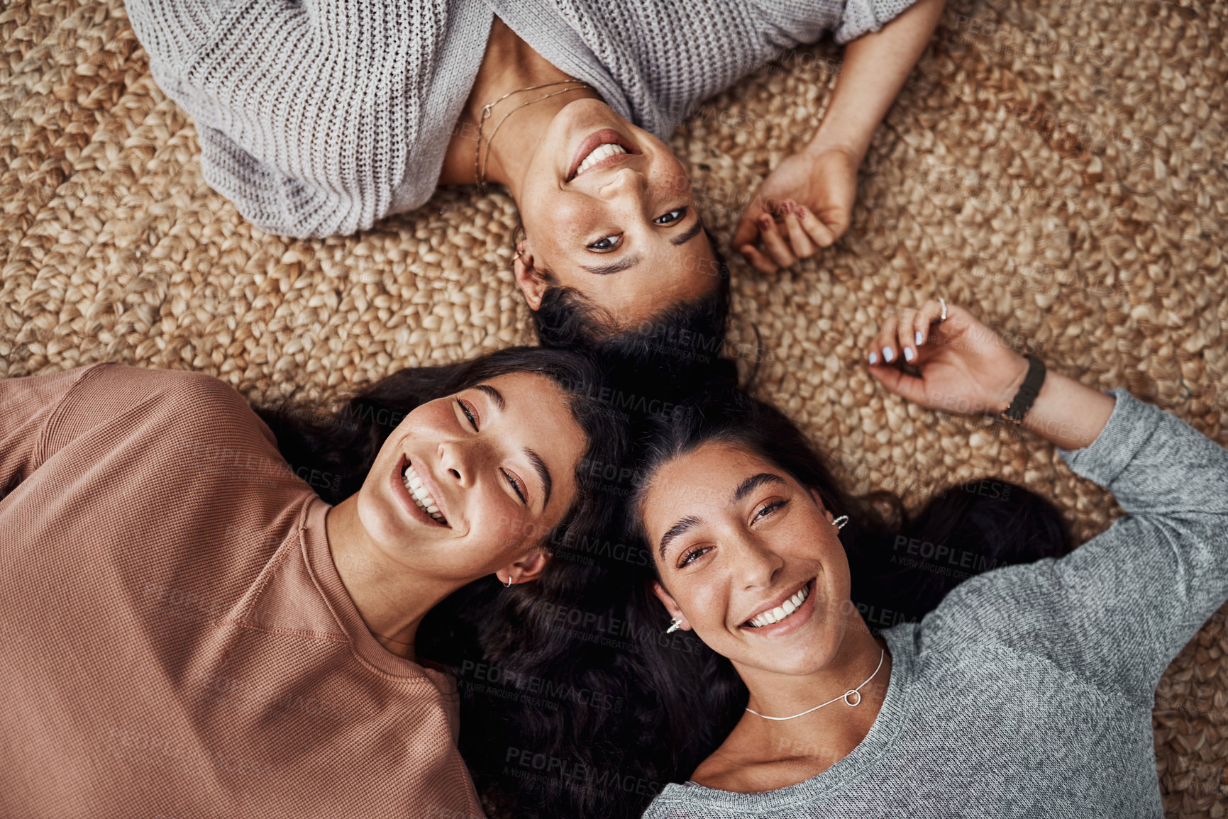 Buy stock photo High angle shot of young sisters relaxing on the floor together at home