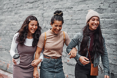 Buy stock photo Cropped shot of an attractive group of sisters bonding during a day out in the city together