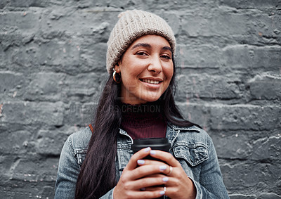 Buy stock photo Cropped portrait of an attractive teenage girl standing against a gray wall in the city and holding a coffee