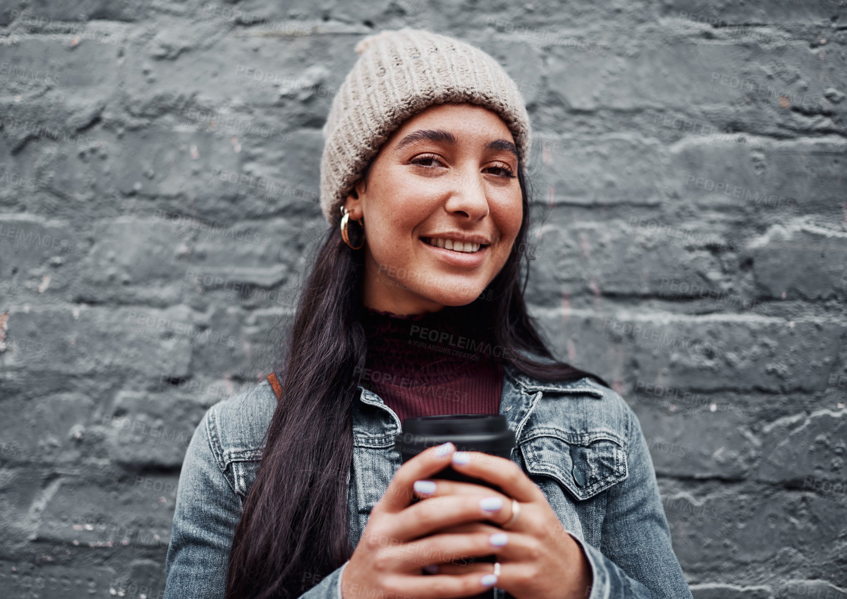 Buy stock photo Cropped portrait of an attractive teenage girl standing against a gray wall in the city and holding a coffee