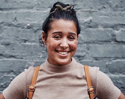 Buy stock photo Cropped portrait of an attractive teenage girl standing alone against a gray wall in the city