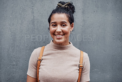 Buy stock photo Cropped portrait of an attractive teenage girl standing alone against a gray wall in the city