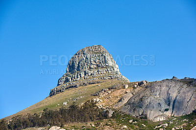 Buy stock photo Scenic landscape of blue sky over the peak of Table Mountain in Cape Town from below with copyspace. Beautiful views of plants and trees around a popular tourist attraction and natural landmark