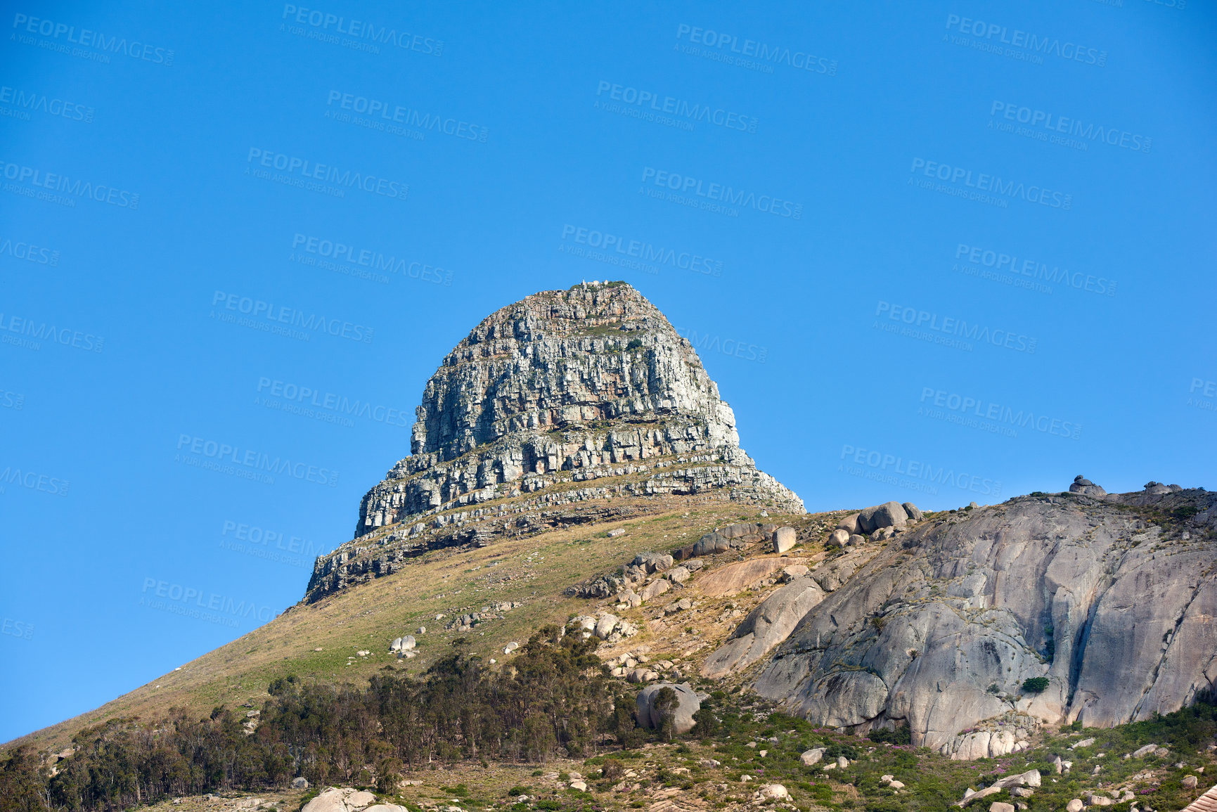 Buy stock photo Scenic landscape of blue sky over the peak of Table Mountain in Cape Town from below with copyspace. Beautiful views of plants and trees around a popular tourist attraction and natural landmark