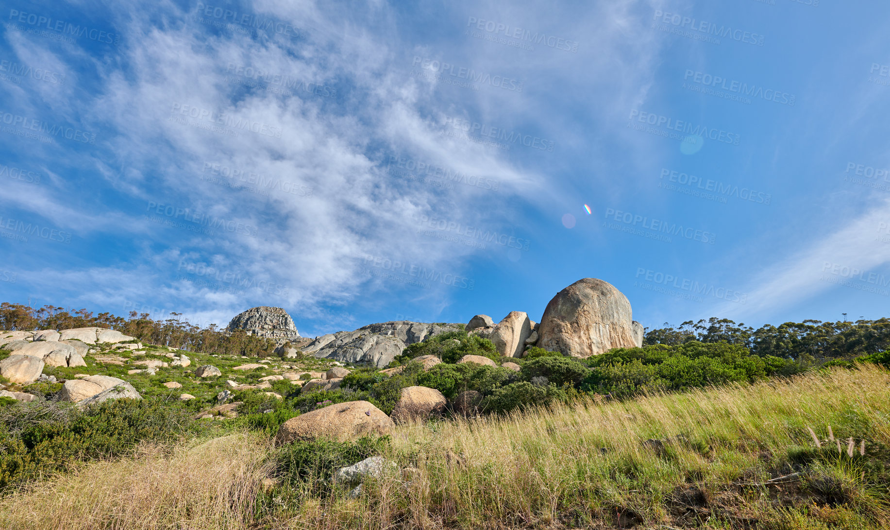 Buy stock photo Copyspace with scenic view of Lions Head mountain in Cape Town, South Africa against a cloudy blue sky background. Beautiful panoramic of a famous travel landmark with lush plants and rocky landscape