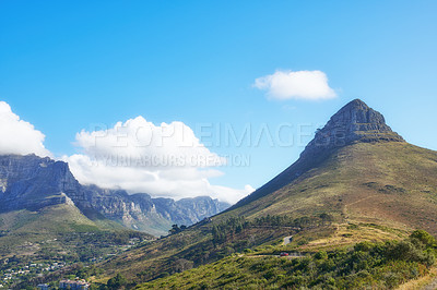 Buy stock photo View of mountains with a path and cityscape against blue sky copyspace. A peaceful mountain with a scenic background in quiet Lions Head in Cape Town, South Africa. Nature backdrop with a hill top