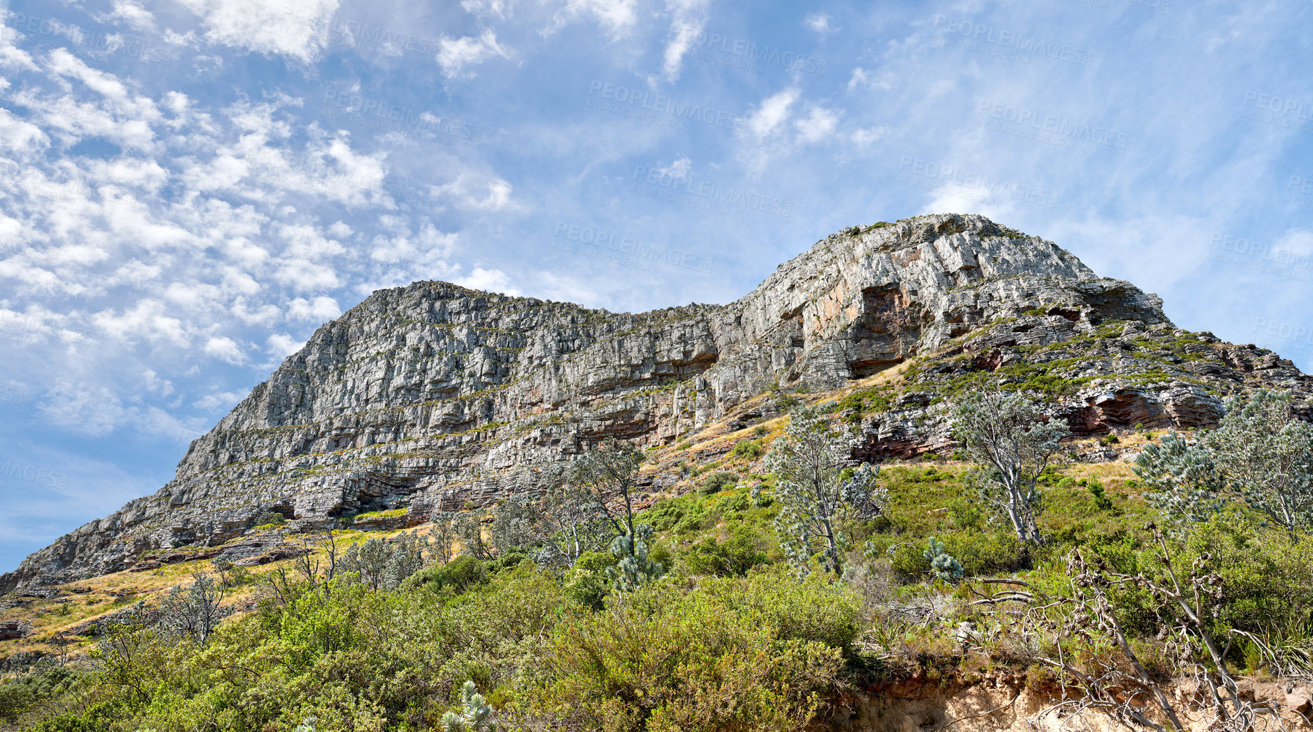 Buy stock photo Landscape view of Lions Head and its natural surroundings in summer. Scenic view of a popular natural landmark in Cape Town, South Africa against a cloudy blue sky. Travel destination for tourists