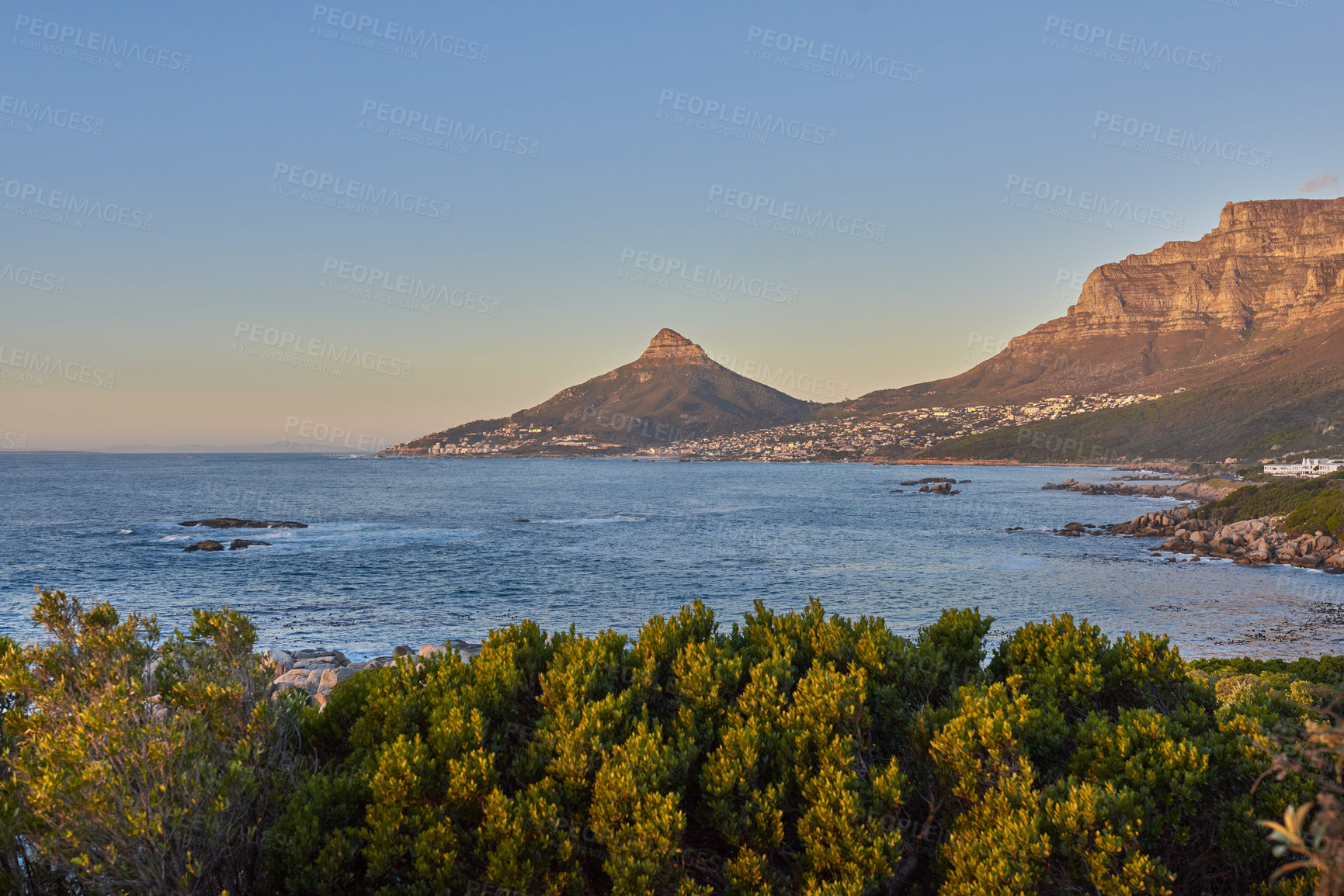 Buy stock photo Scenic landscape view of Lion's Head and seashore during summer. Beautiful scenery of sea and mountain against  blue sky background. Table mountain and the ocean during dusk in a popular tourist town