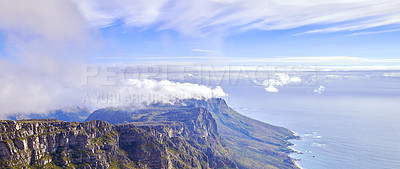 Buy stock photo Clouds covering Table mountain in Cape town, South Africa with copyspace. Rocky terrain, mountain peaks in peaceful harmony with coastal views. Calm, fresh, and soothing nature on a tranquil morning 