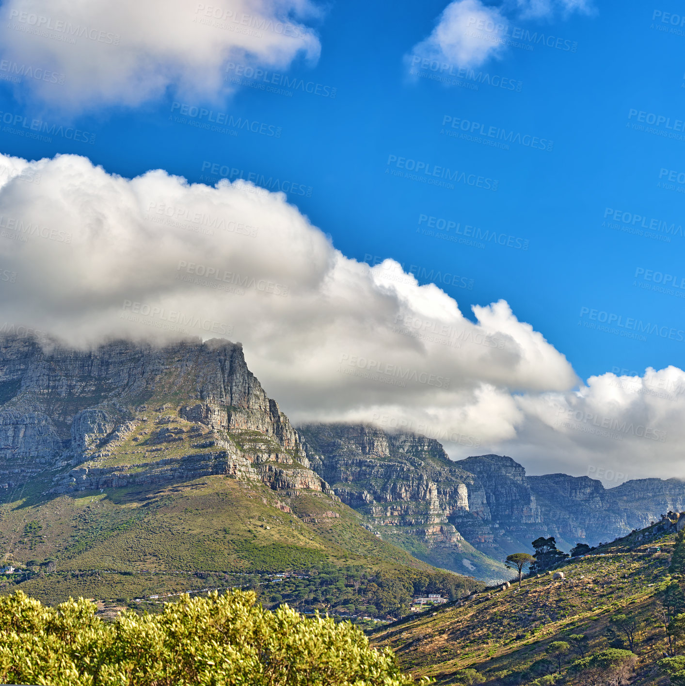 Buy stock photo Thick clouds rolling over Table Mountain, Cape Town with copyspace. Cloud shadows passing rocky terrain on sunny day, beautiful, peaceful nature in harmony with soothing view of plants and landscape