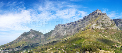 Buy stock photo Panoramic view of Table Mountain against a cloudy blue sky with copyspace. Vibrant, beautiful landscape of nature. A popular location in Cape Town for travel, hiking and adventure